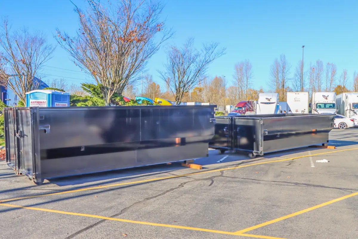Professional dumpster rental service with roll-off container on residential driveway in East Renton Highlands